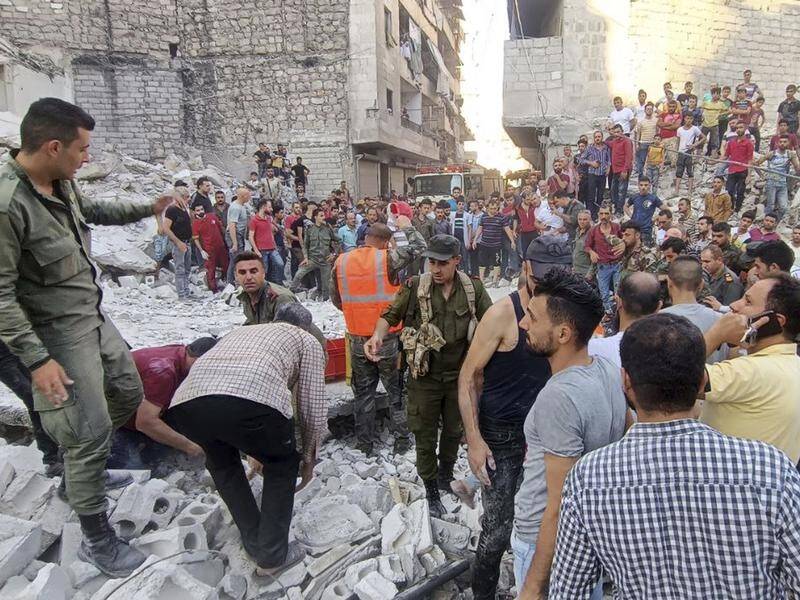 Emergency workers continue to search for victims under the rubble of a destroyed building in Aleppo. (AP PHOTO)