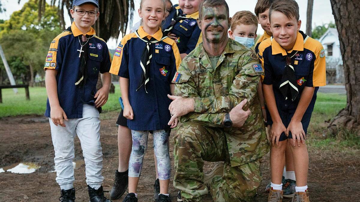 Army soldier Private Luke Badgery from 7th Battalion, Royal Australian Regiment, shows 1st Lismore Scout Group scouts how to apply camouflage cream. Photo: Private Johnny Huang