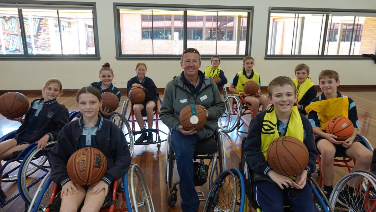 Australian Paralympian wheelchair tennis player and silver-medallist David Johnson with primary school students from the Northern Rivers