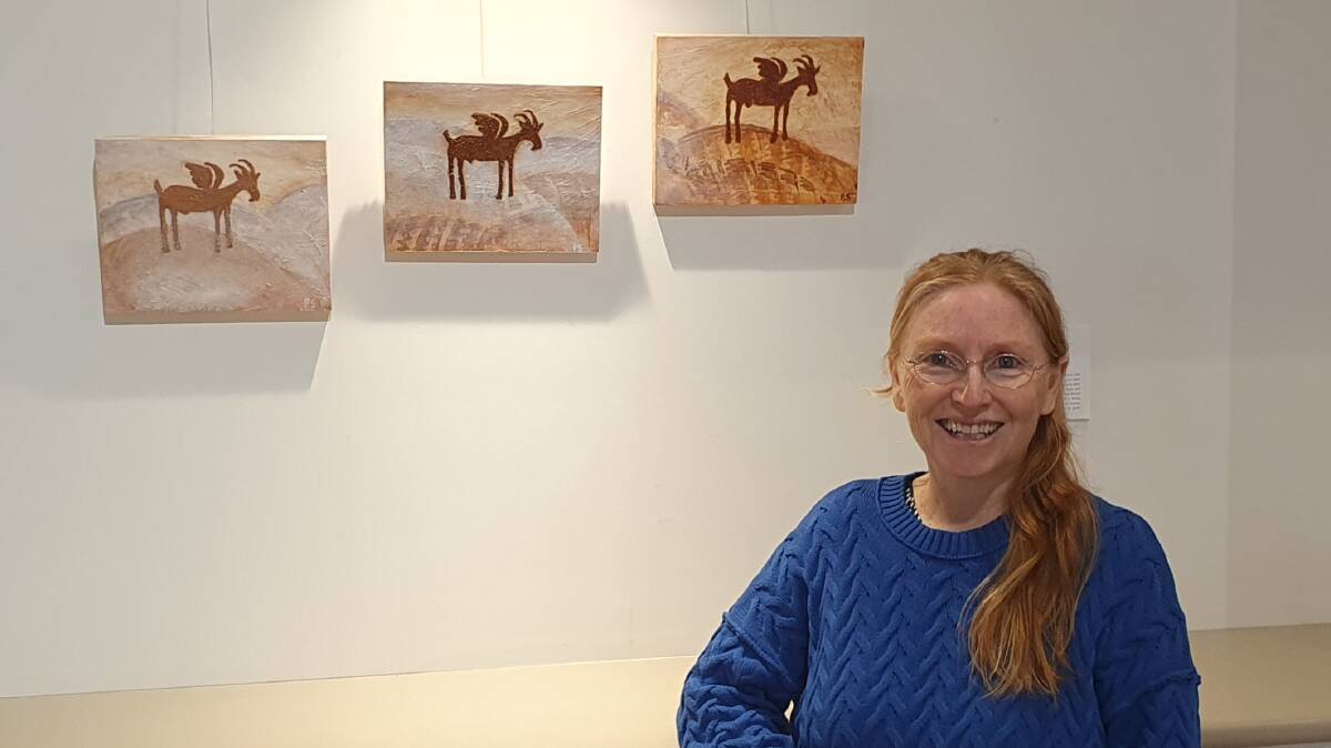 Penelope Sienna, at the Mud & Ink exhibition at the Roxy Gallery, next to her work titled "Farewell", a tribute to all the livestock and pets lost in the 2022 floods. Picture supplied