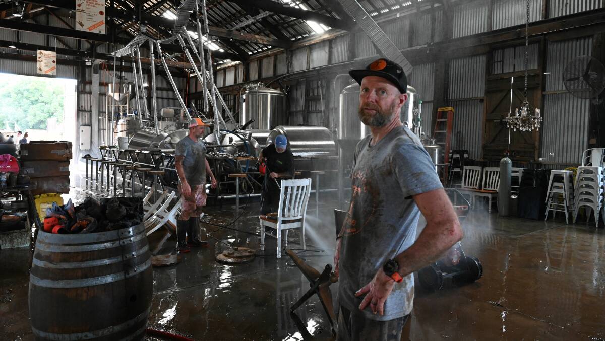 GROUNDHOG DAY: Grant Smith (left background) and Andrew Newton from Two Mates Brewing in South Lismore, cleaning up after the flood on February 28. Picture: Cathy Adams
