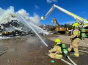 Firefighters fighting the blaze at a Hexham scrap metal yard. Picture: Fire and Rescue NSW