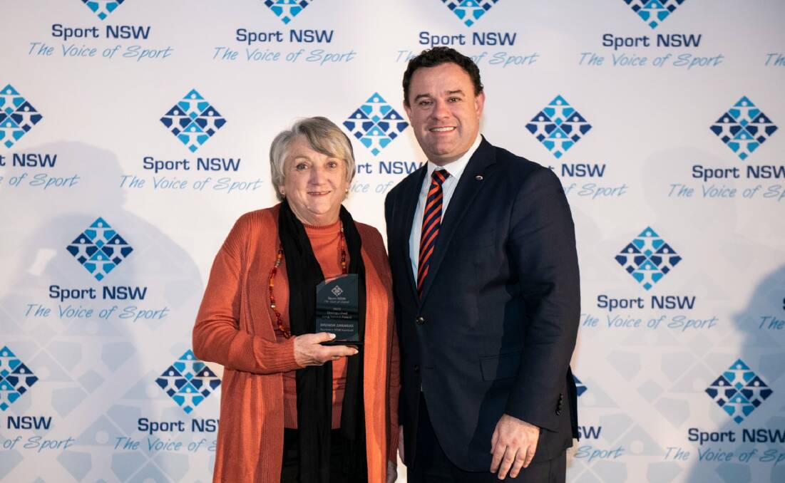 WELL DESERVED: Football Far North Coast volunteer Barbara Zakaras receives a Distinguished Long Service Award from Minister for Tourism and Sport, Stuart Ayres. Picture: Sport NSW