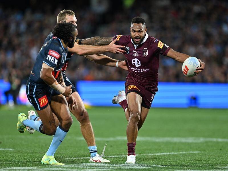 Hamiso Tabuai-Fidow (right) fends off Tom Trbojevic and Josh Addo-Carr of the Blues during Origin. (Dave Hunt/AAP PHOTOS)