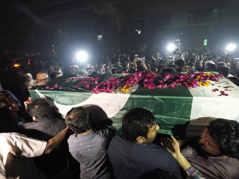 People carry the coffin of a journalist who died after falling under former PM Imran Khan's truck. (AP PHOTO)