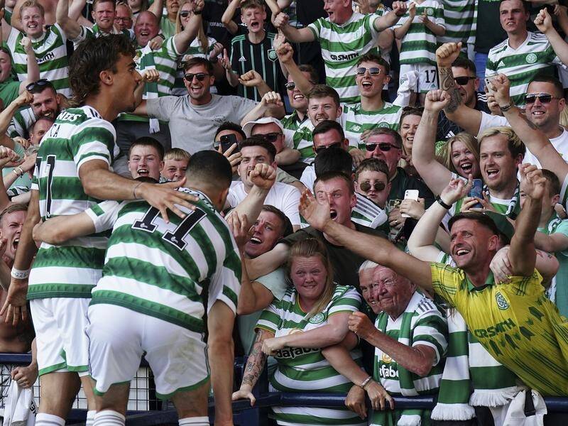Celtic fans hail Jota (left) after his goal sealed a Scottish Cup win for Ange Postecoglou's side. (AP PHOTO)